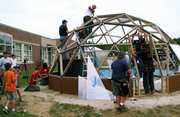 FARjaydome1P061310jpg - Growing Spaces Greenhouses people building a geodesic dome greenhouse from afar
