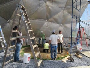 Volunteers constructing a Growing Dome greenhouse