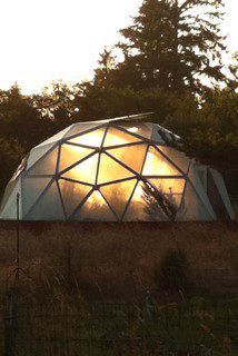 22' Growing Dome Greenhouse at Green Angel Gardens in Long Beach, WA during a sunset
