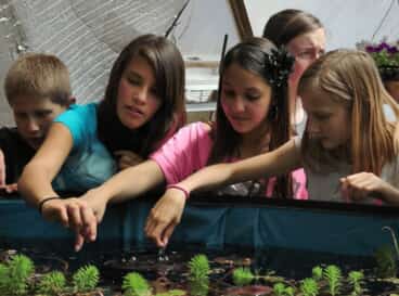 4 - Growing Spaces Greenhouses School Kids learning in a Growing Dome Greenhouse above ground pond