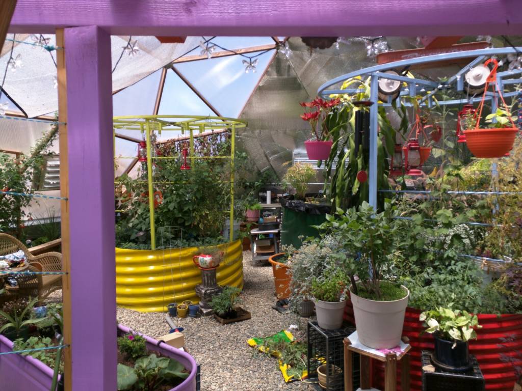 colorful planting beds in geodesic dome greenhouse