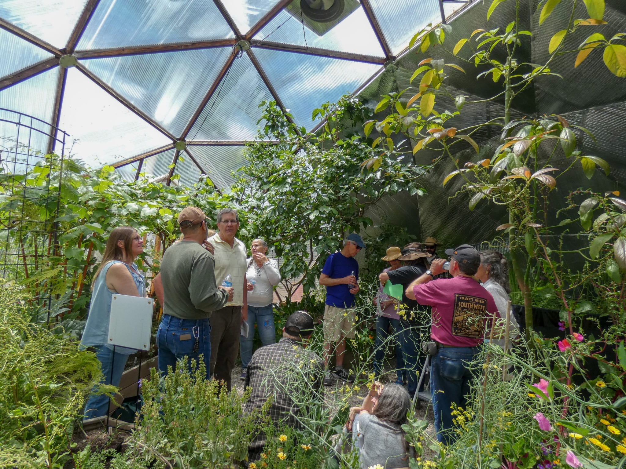 people taking a class in a growing dome greenhouse