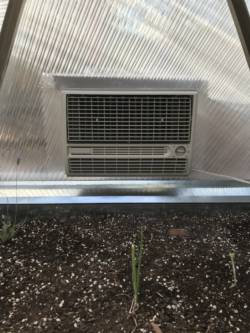 looking at an evaporative cooler from the inside of a growing dome to cool a greenhouse