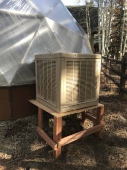 evaporative cooler mounted outside on a stand Growing Dome Greenhouse