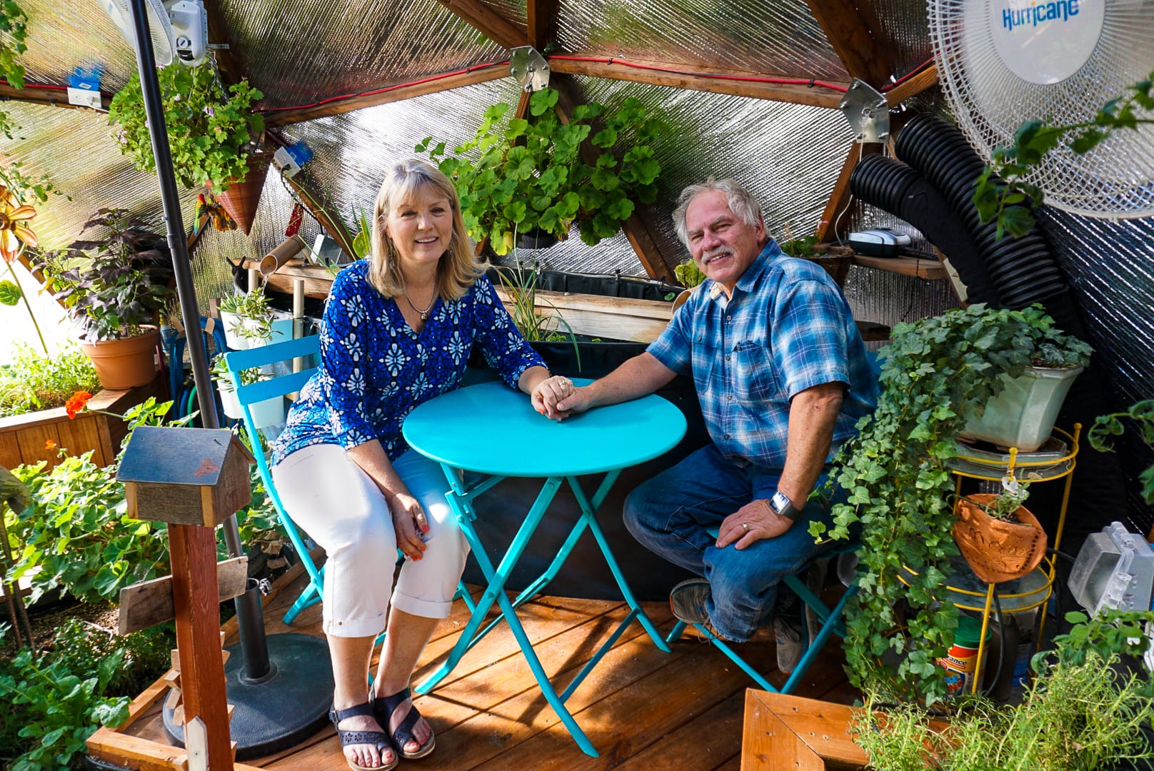 The Swamks in their custom garden greenhouse