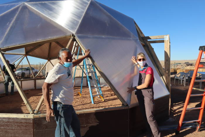 Tyrone Thompson and Megan installing a vent for the Growing Dome Greenhouse on Navajo Nation