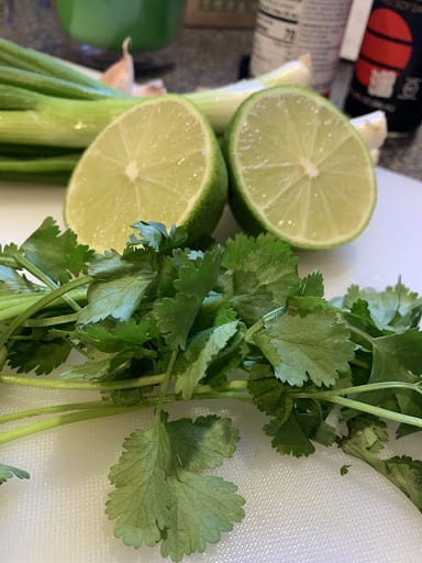 cilantro and lime on a cutting board
