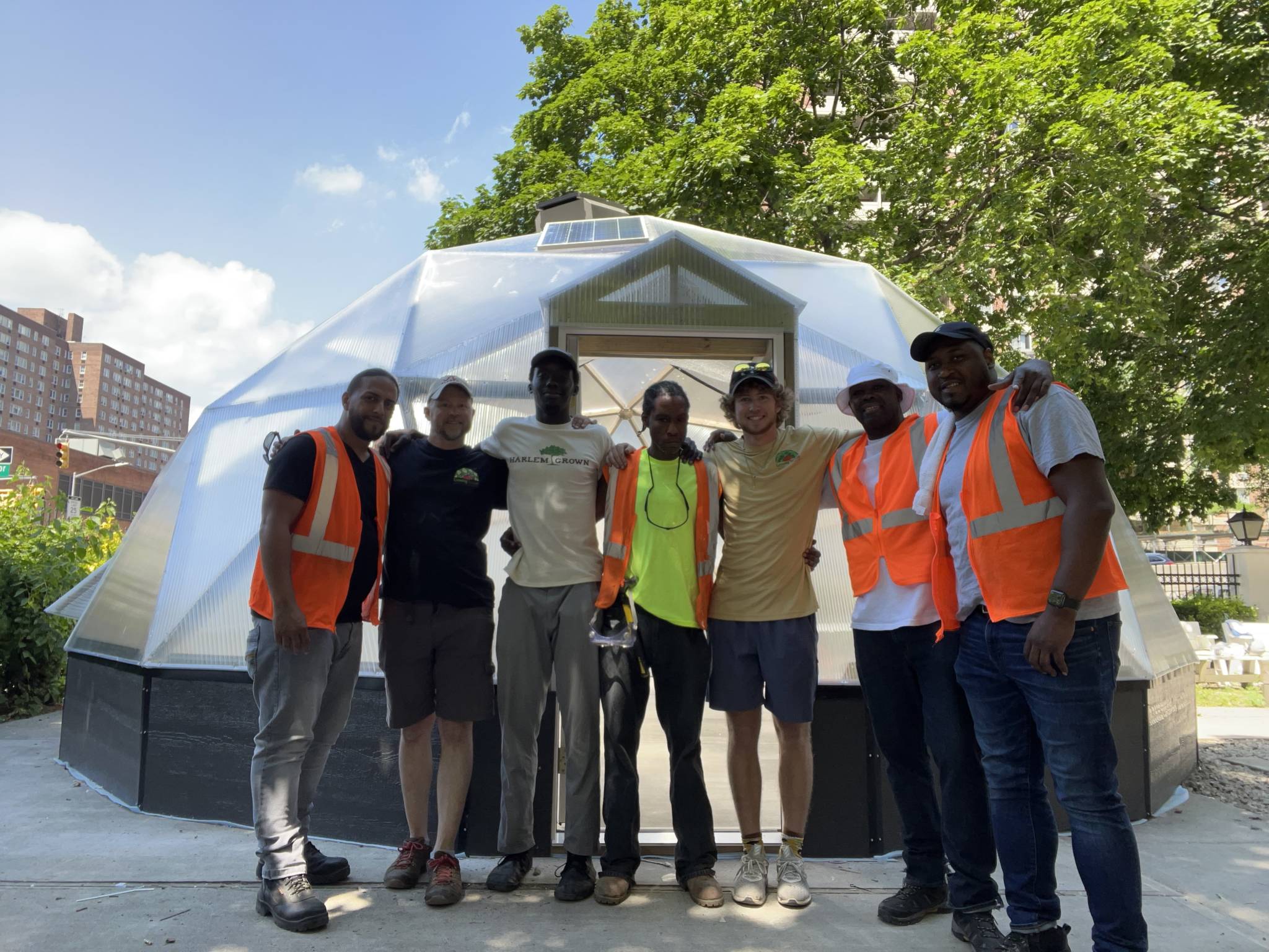 Harlem-Grown-Urban-Greenhouse - Growing Spaces Greenhouses community members pictured in front of Urban Greenhouse being built in Harlem