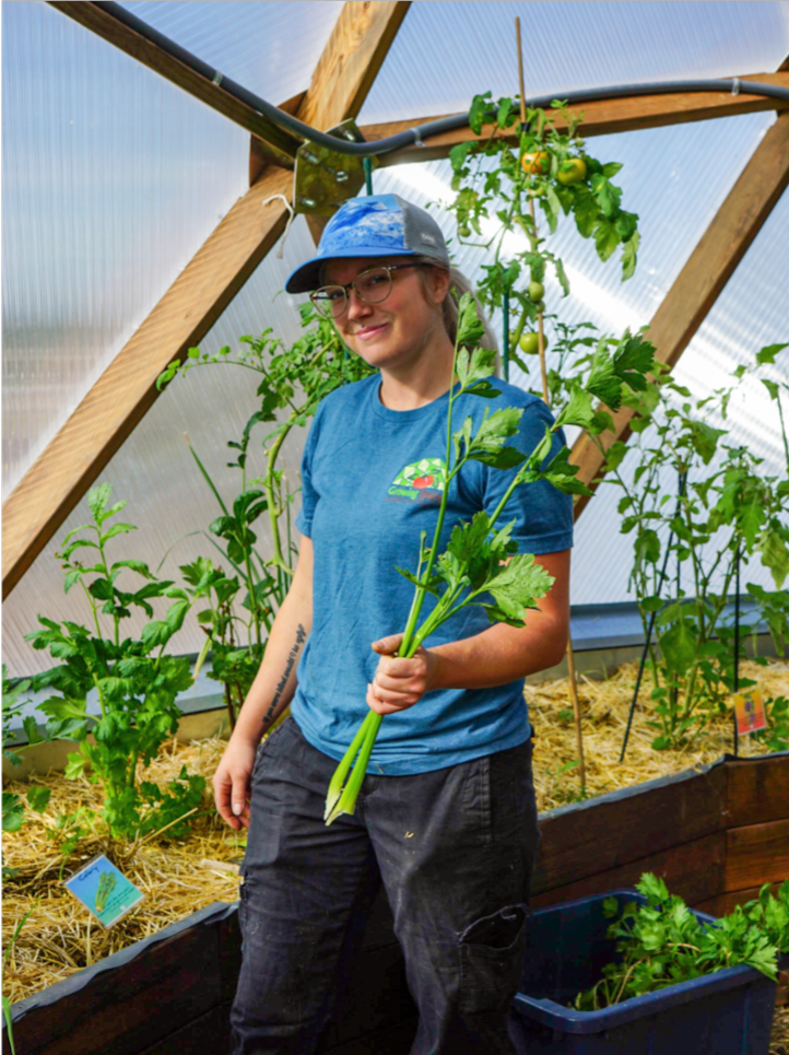 Desiree_Celery - Growing Spaces Greenhouses Gardener Holding Indoor Grown Celery