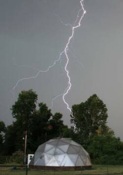 Growing Dome greenhouse under a lightning bolt during a storm in Oklahoma