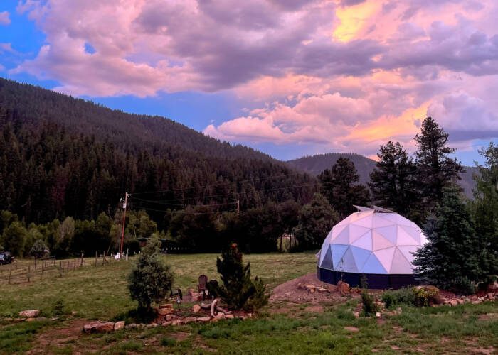 Backyard Greenhouse in Pagosa Springs Colorado under a beautiful purple sunset
