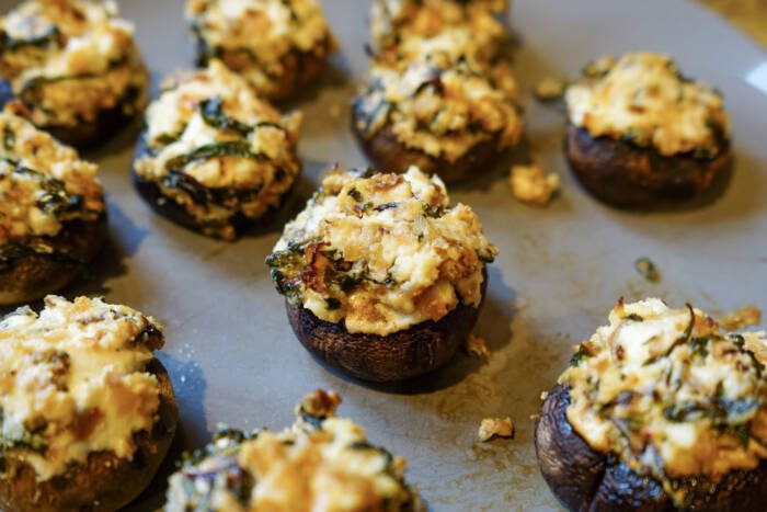 cooked and plated Swiss chard and goat cheese stuffed mushrooms