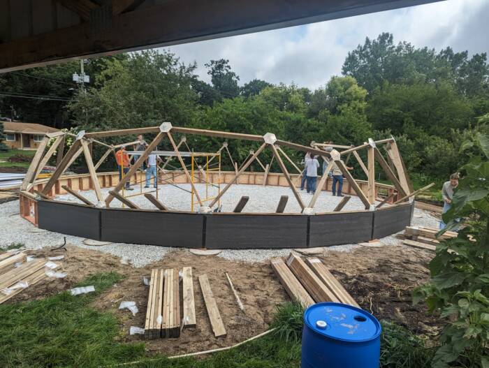 ReEntry program volunteers building their growing dome greenhouse