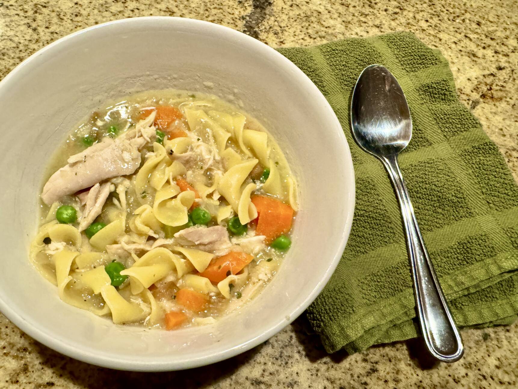 Leftover turkey meat being added to soup