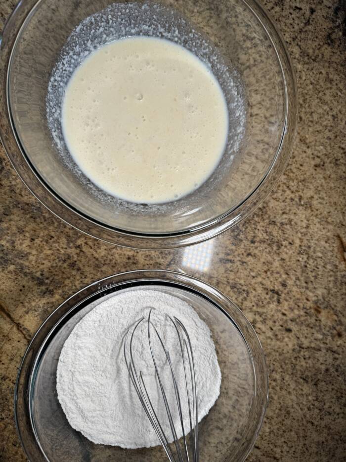 wet and dry banana pancakes in bowls ready to be mixes