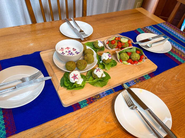 Table set for dinner of borage tzatziki and gluten-free falafel