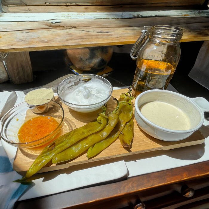 ingredients for the relleno batter egg separated with whites whipped to stiff peaks, 4 green chiles roasted peeled and seeded, quart jar filled with oil, masa, bowl of pancake batter