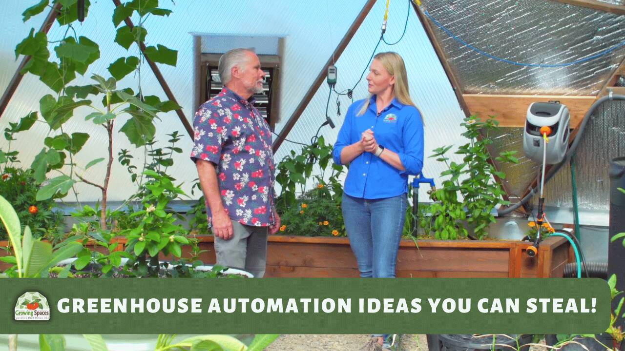 A man and woman having a conversation in a geodesic greenhouse with a hose reel and plants behind them