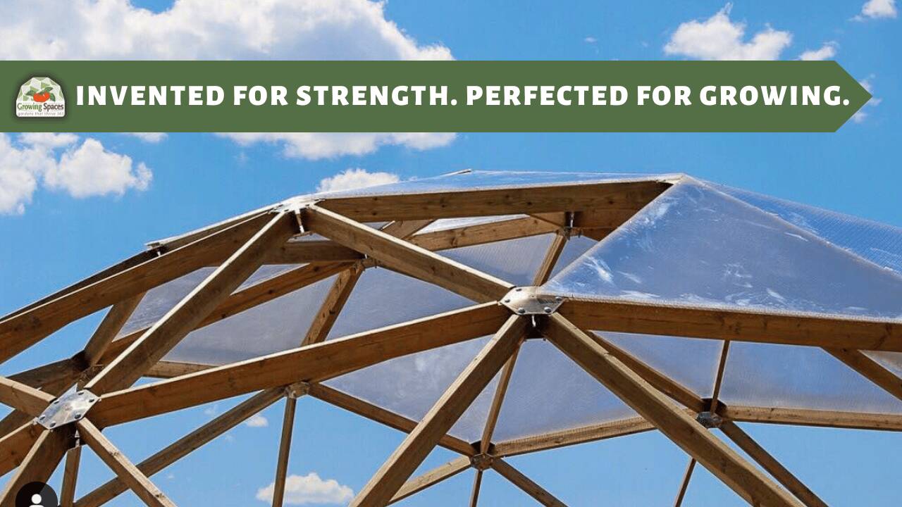 Geodesic Dome Structure with some glazing panels installed and a blue sky in background with small clouds