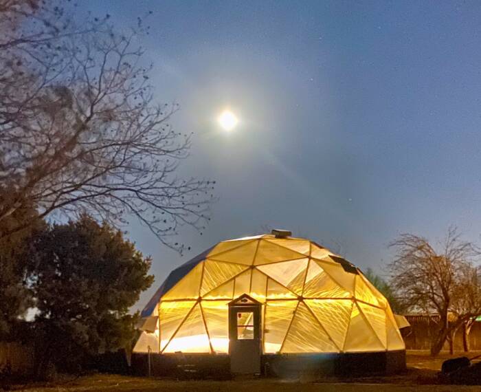 Loveless-Wind - Growing Spaces Greenhouses Growing Dome illuminated in the evening light under a full moon